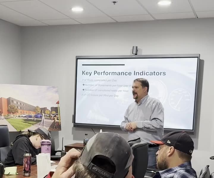 Jason Dixon leading a key performance indicator training session with a production crew in a conference room